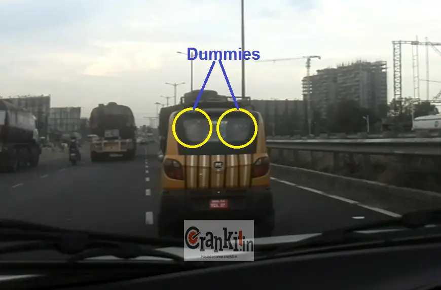 Bajaj Qute carrying dummies on rear seat